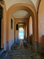 Fototapeta premium Portico in Levanto on the coast of Ligurian sea, with blue water in the background