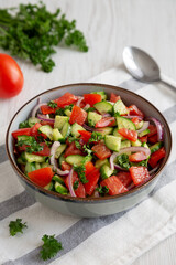 Homemade Mediterranean Cucumber Tomato Salad in a Bowl, side view.