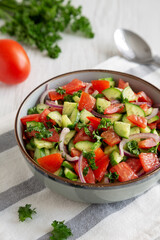 Homemade Mediterranean Cucumber Tomato Salad in a Bowl, side view.