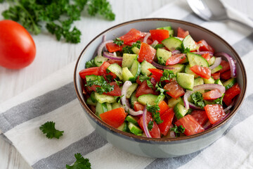 Homemade Mediterranean Cucumber Tomato Salad in a Bowl, side view.
