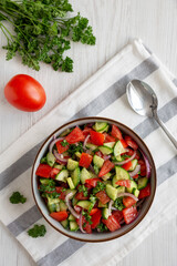 Homemade Mediterranean Cucumber Tomato Salad in a Bowl, top view. Flat lay, overhead, from above.