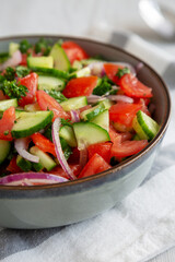 Homemade Mediterranean Cucumber Tomato Salad in a Bowl, side view. Close-up.