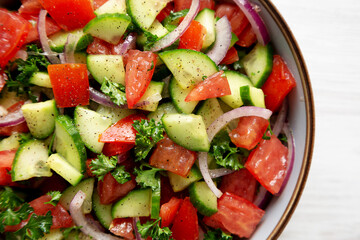 Homemade Mediterranean Cucumber Tomato Salad in a Bowl, top view. Flat lay, overhead, from above.
