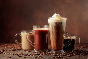 Various coffee and chocolate drinks on a brown background.