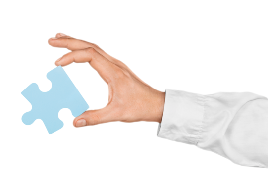 Businessman Hand Holding a Puzzle Piece
