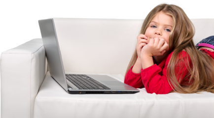 Cute little girl using laptop on sofa isolated on white background
