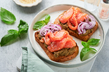 Sandwiches with salted salmon, avocado guacamole, red onions and basil. Smorrebrod. Set of danish...