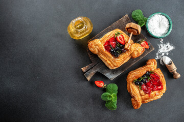 Obraz na płótnie Canvas yummy berry puff pastry with berries on a dark background. banner, menu, recipe place for text, top view