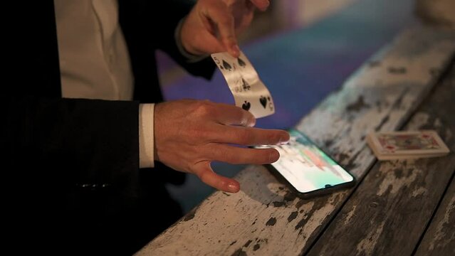 Slow revealing shot of a magician opening up a signed playing card at a table