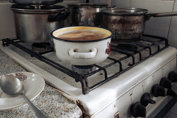Cooking soup in a pot on an old gas stove