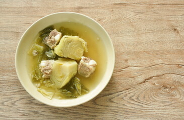 boiled pickled cabbage with pork bone in clear soup on plate
