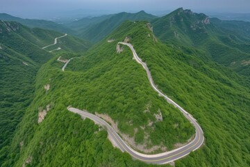aerial view of a winding mountain road, with views of the valley below, created with generative ai