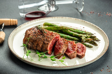 Barbecue steak with green asparagus and red wine. Healthy dinner or lunch