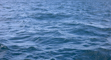 Blue sea water surface texture. Blue ocean summer