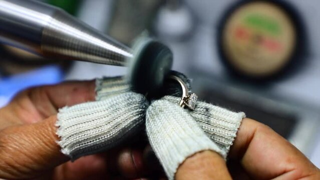 Production of diamond rings. Jeweler polishing ring.wedding jewelery making.