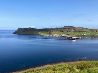 Fototapeta na wymiar A spectacular view of the Isle of Skye and its rugged coastline of cliffs on a sunny blue sky summer day