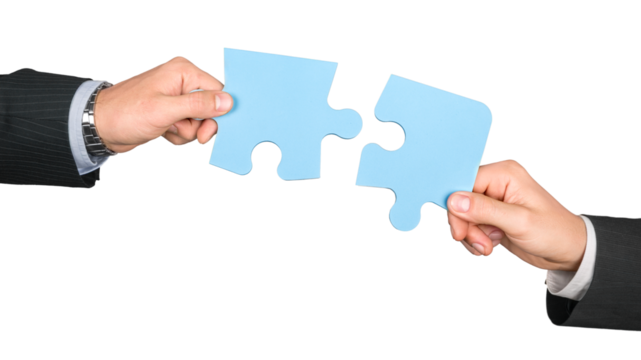 Closeup on Businesspeople Combining Puzzle Pieces Together