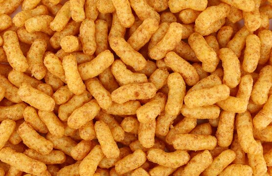 Puffed peanuts and corn snacks. Background and texture, full frame.