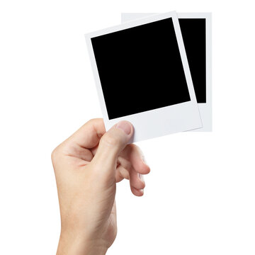 Hand holding instant photo cards cut out