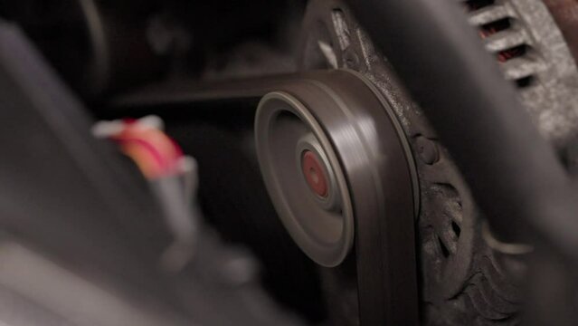 Belt spinning on a wheel, car engine belt, timing belt cog