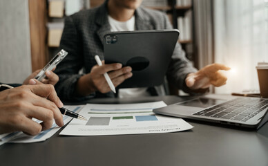 Business men explaining a project to his team.