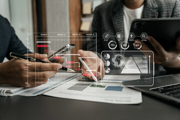Business team hand Project manager working and update tasks and Gantt chart scheduling virtual diagram.with smart phone, tablet and laptop in office.