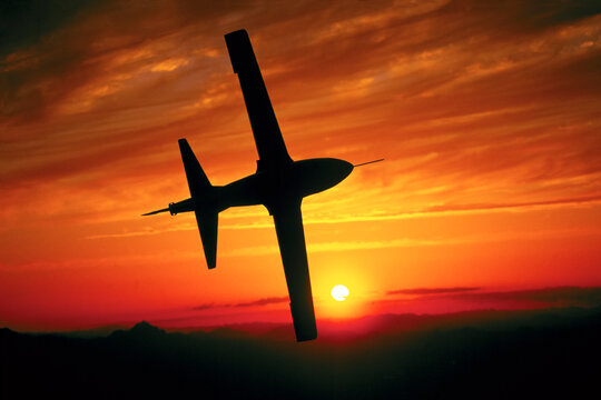 Micro-Jet silhouetted against a golden sky at sunset; Tucson, Arizona, United States of America