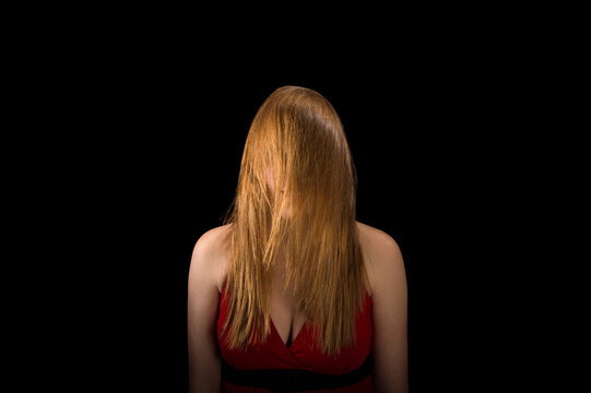Young woman's long hair obscures her face; Lincoln, Nebraska, United States of America