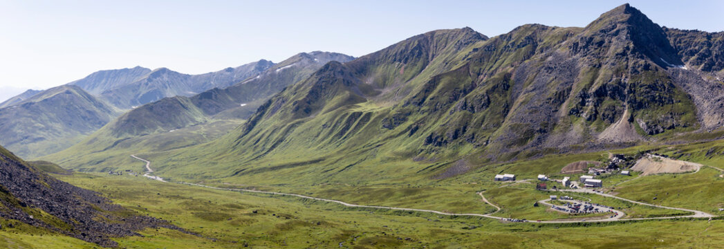 Independence Mine State Historical Park Visitor Center surrounded by the Talkeetna Mountains across Hatcher Pass under a sunny, blue sky; Palmer, Alaska, United States of America