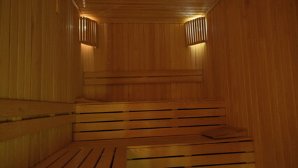 Fototapeta na wymiar sauna room with wooden sitting groups surrounded by wood