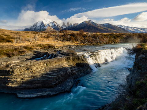 Scenic view of Cascada Rio Paine with the Cuernos Del Paine mountain peaks in the distance; Torres del Paine National Park, Patagonia, Chile