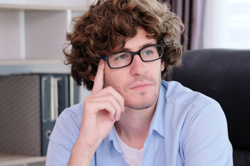 Young businessman sitting thinking business plan.