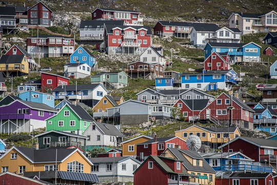 Fototapeta Close-up view of the colorful buildings on the rocky cliffs along the shore in the seaport town of Qaqortoq on Greenland's southern tip  Qaqortoq, Southern Greenland, Greenland