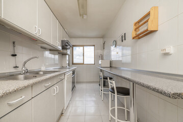 Elongated kitchen with cabinets on one side