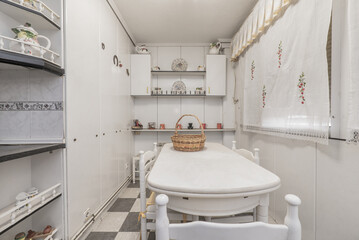 Corner of a kitchen with furniture in the background