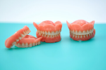 Dentures on top of a green work table in a denture clinic.