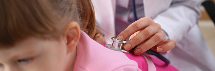 Little girl at doctor lung area examined with stethoscope. Cough bronchitis and asthma in children - obrazy, fototapety, plakaty