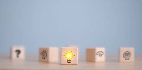 Wooden cube block which print screen lightbulb icon on face with gear, creative idea and innovation...
