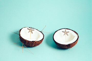 Coconut with starfish. Coconut on turquoise background. Copy space