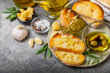 Italian ciabatta bread with olives, garlic, parmesan and rosemary on a dark marble background. Tasty food. Aperitif. Place for text. copy space. Delicacy. Bon appetit.