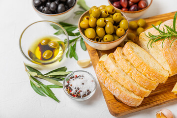 Italian ciabatta bread with olives, garlic, parmesan and rosemary on a light concrete background. Tasty food. Aperitif. Place for text. copy space. Delicacy. Bon appetit.