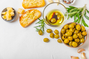 Italian ciabatta bread with olives, garlic, parmesan and rosemary on a light concrete background. Tasty food. Aperitif. Place for text. copy space. Delicacy. Bon appetit.