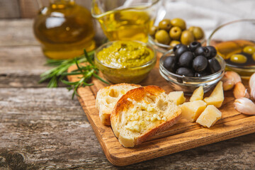 Italian ciabatta bread with olives, garlic, parmesan and rosemary on texture wooden background. Tasty food. Aperitif. Place for text. copy space. Delicacy. Bon appetit.