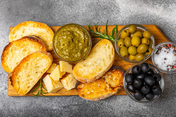Italian ciabatta bread with olives, garlic, parmesan and rosemary on a dark marble background. Tasty food. Aperitif. Place for text. copy space. Delicacy. Bon appetit.