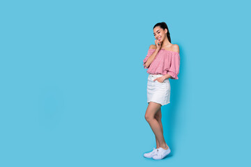 Full body photo of young model japanese girl wear mini skirt pink top free shoulders posing for magazine isolated on blue color background