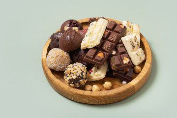 Wooden plate with healthy craft natural candies and mini chocolates. Sweet food, healthy dessert