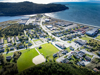 Aerial Newfoundland town of Placentia overlooking baseball diamonds and sports fields with sandy beaches in Atlantic Canada.