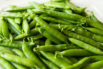 Fresh green peas on a wooden background. Summer crop of peas.