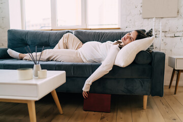 Pregnant woman sleeping on sofa