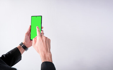 cellphone taken from hands with isolated background, businessman cellphone in hands, cellphone concept with green background